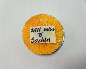 View larger photo: A farewell cake adorned in yellow hues featuring a heartfelt "will miss you" message.